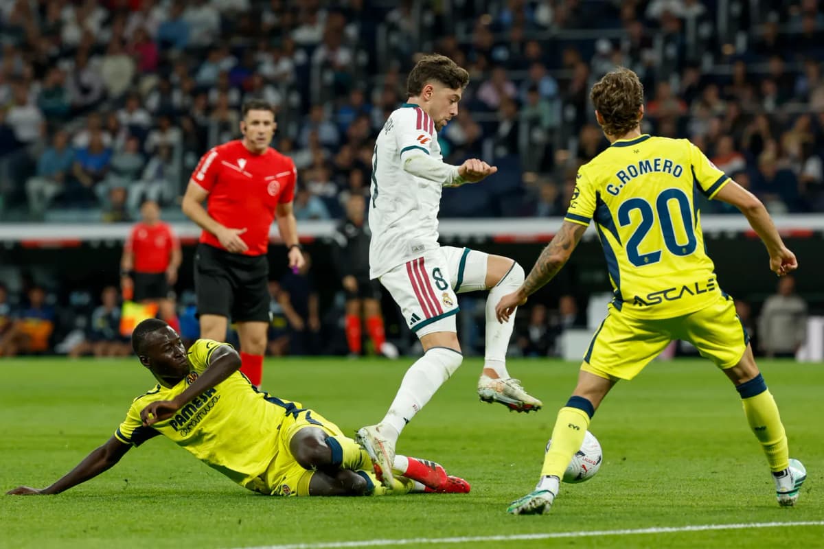 El centrocampista del Real Madrid Federico Valverde (c) supera la defensa de Pape Alassane Gueye (i), del Villarreal CF, durante el partido de LaLiga de…