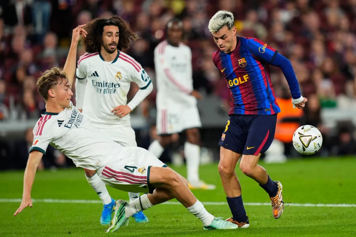 El defensa del Real Madrid Dean Huijsen (i) pelea un balón con el centrocampista del Barcelona Pedri durante el encuentro de LaLiga EA Sports que disputaron…