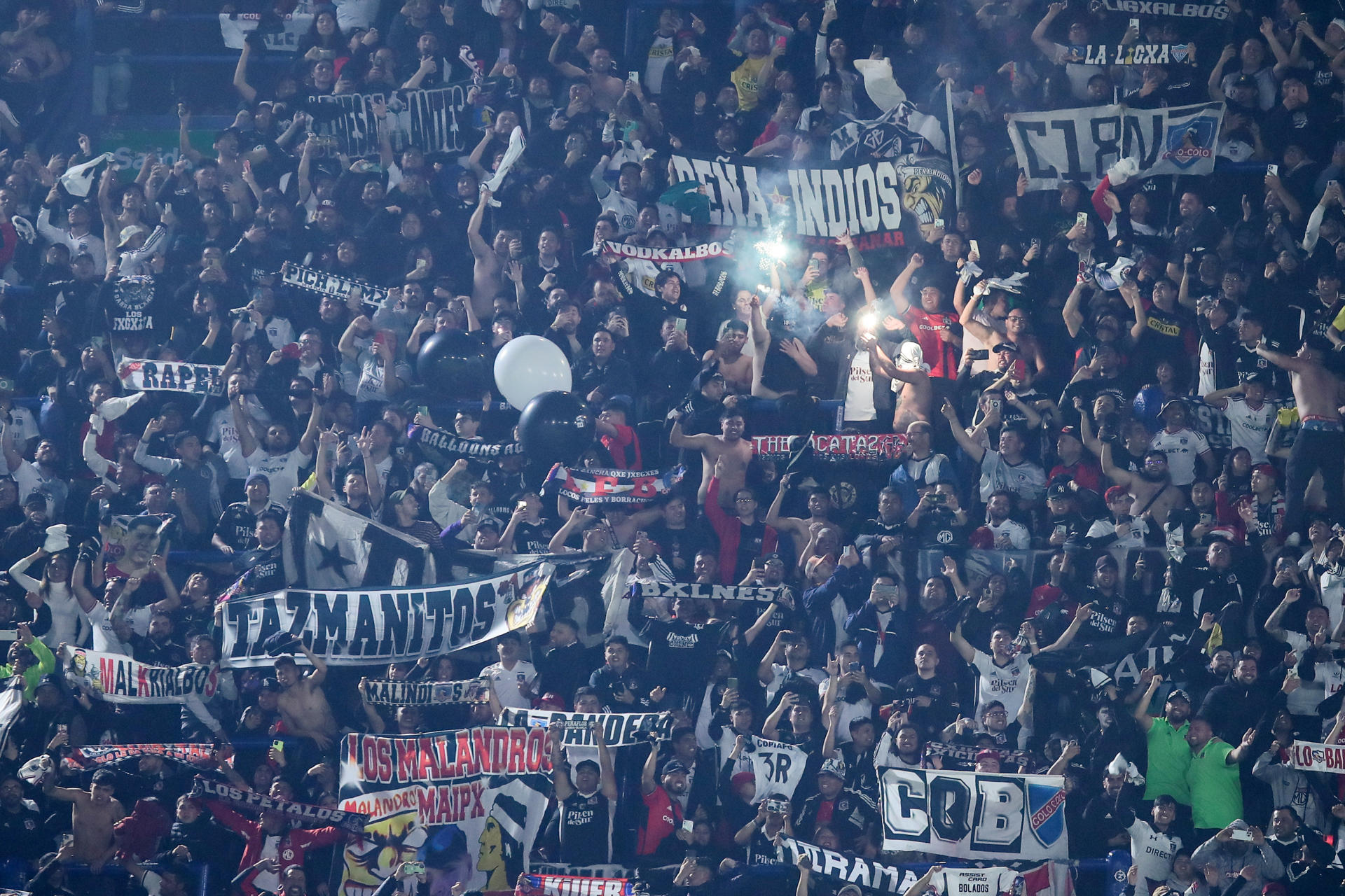 Hinchas de Colo Colo apoyan al equipo , en un partido de la fase de grupos de la Copa Libertadores entre Boca Juniors y Colo Colo en el estadio La Bombonera en Buenos Aires (Argentina). EFE/ Luciano González