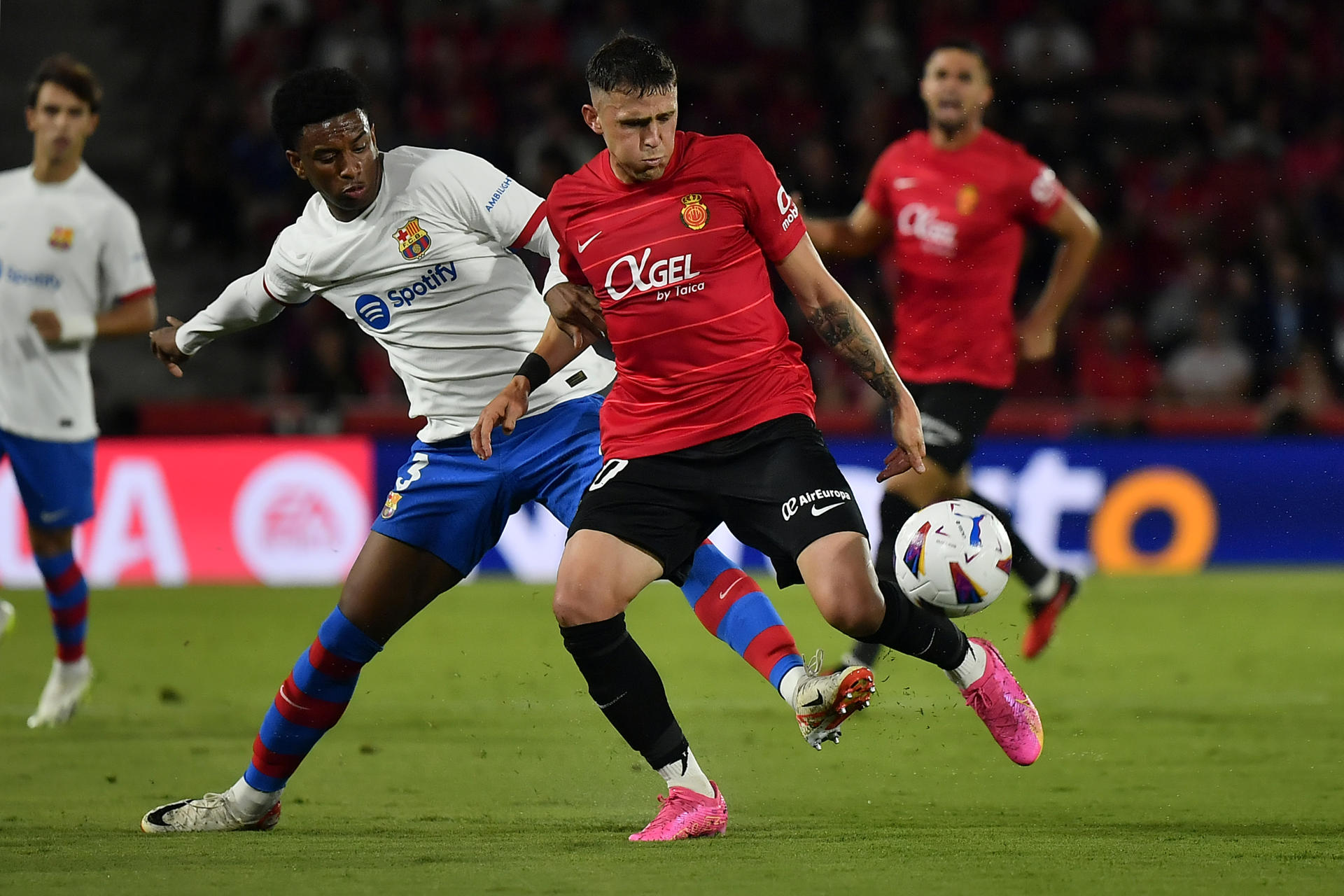 El defensa uruguayo del Mallorca Gio González (d) disputa un balón ante el centrocampista Alejandro Baldé del Barcelona este martes, durante el partido de LaLiga, entre el RCD Mallorca y el FC Barcelona, en Son Moix, Palma de Mallorca. EFE/ Miquel A. Borràs 