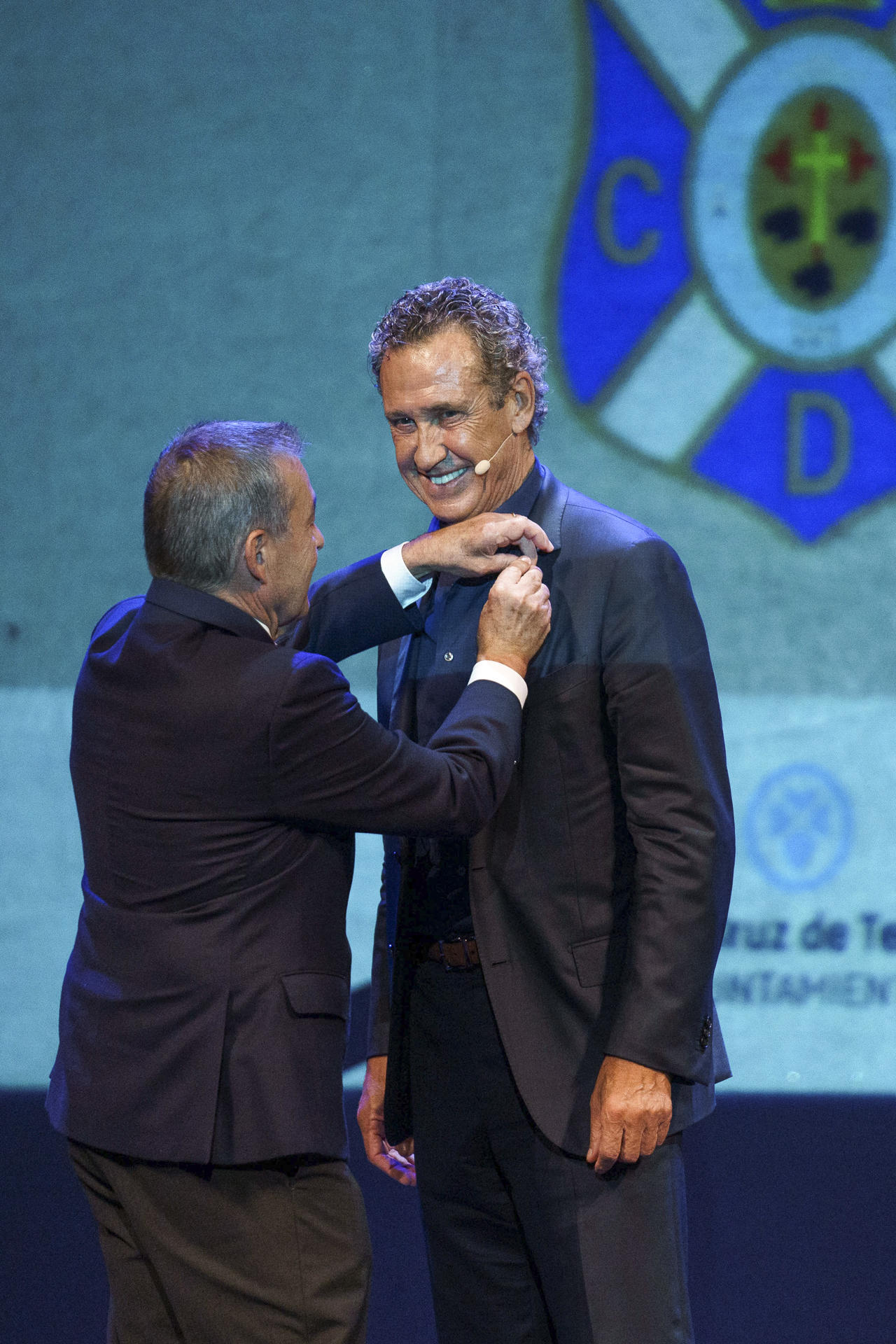 El exentrenador del CD Tenerife, Jorge Valdano, recibe este jueves, de mano del presidente del club, Paulino Rivero, la insignia de oro y brillantes de la entidad blanquiazul con motivo de los 30 años del debut del CD Tenerife en Europa 1993-2023, durante un acto celebrado en el Teatro Guimerá de Santa Cruz de Tenerife. EFE/ Ramón de la Rocha 