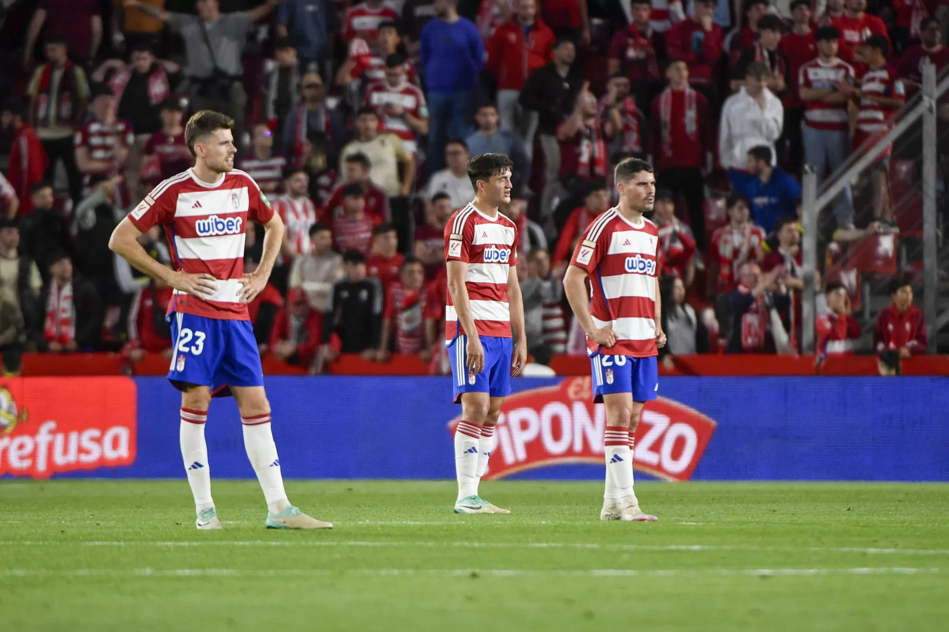 Los jugadores del Granada tras encajar el gol ante el Valencia, durante el partido de LaLiga que Granada CF y Valencia CF han disputado este jueves en el estadio Nuevo Los Cármenes. EFE/Miguel Ángel Molina