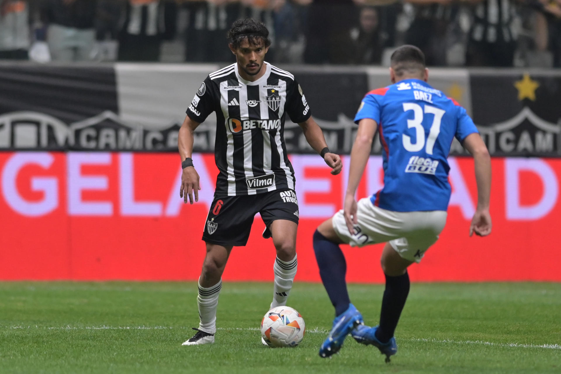 Gustavo Scarpa (i) de Mineiro disputa un balón con Elías de Jesús Báez de San Lorenzo en el partido de vuelta de octavos de final de la Copa Libertadores. EFE/ Yuri Edmundo 