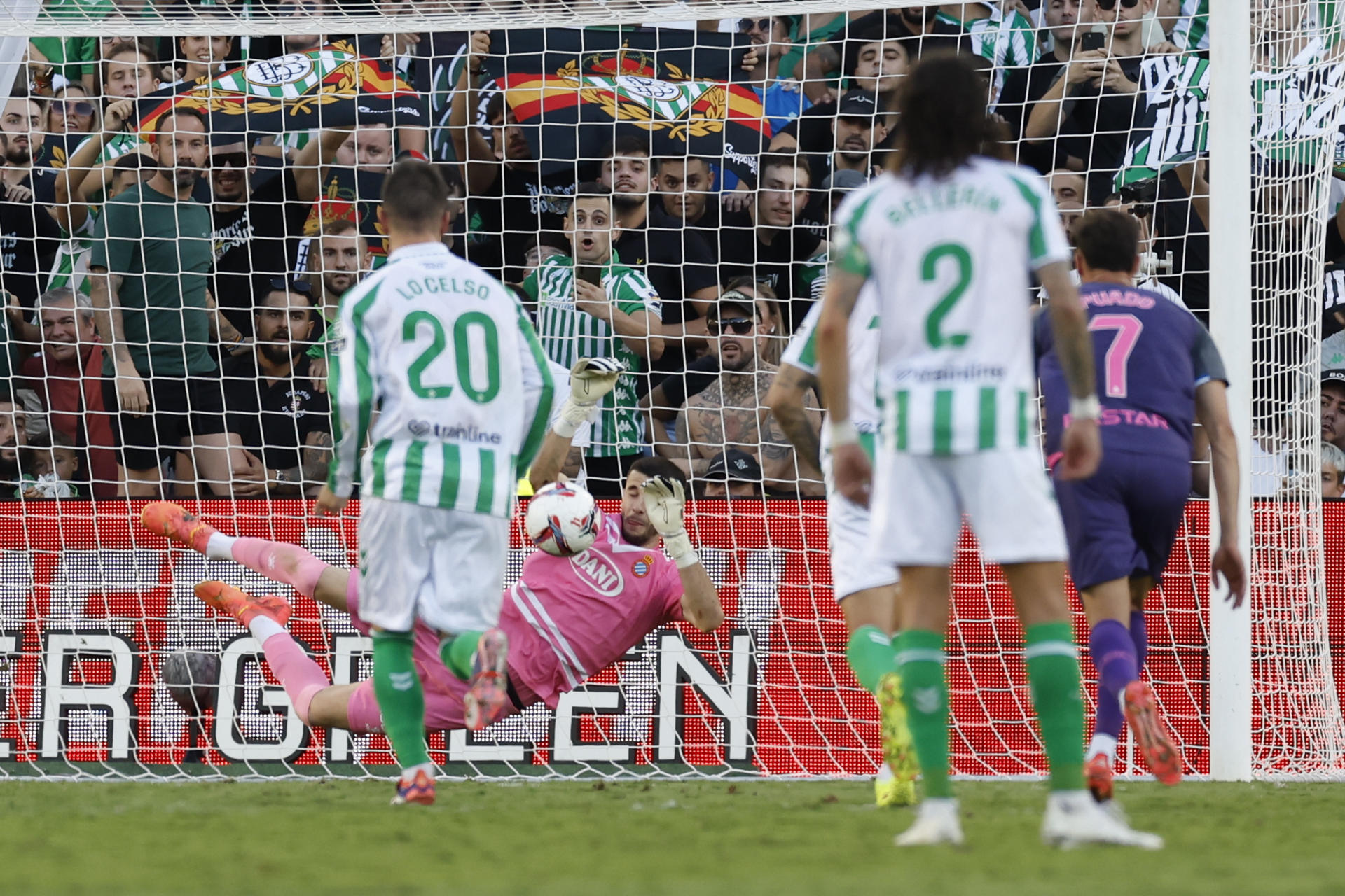 El portero del Español, Joan García (2-i), detiene un lanzamiento de penalti durante el partido de LaLiga en Primera División en el estadio Benito Villamarín, en Sevilla. EFE/Julio Muñoz 