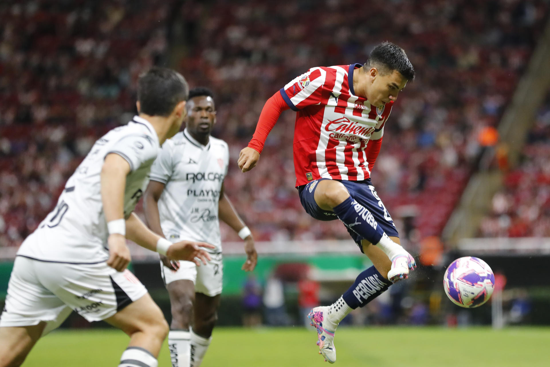Fernando Beltrán (d) del Guadalajara disputa el balón con Brayan Garnica (i) de Necaxa este martes durante un partido de la jornada 13 del torneo apertura 2024 de la liga del fútbol mexicano disputado en el Estadio Akron en la ciudad de Guadalajara, Jalisco (México). EFE/ Francisco Guasco 