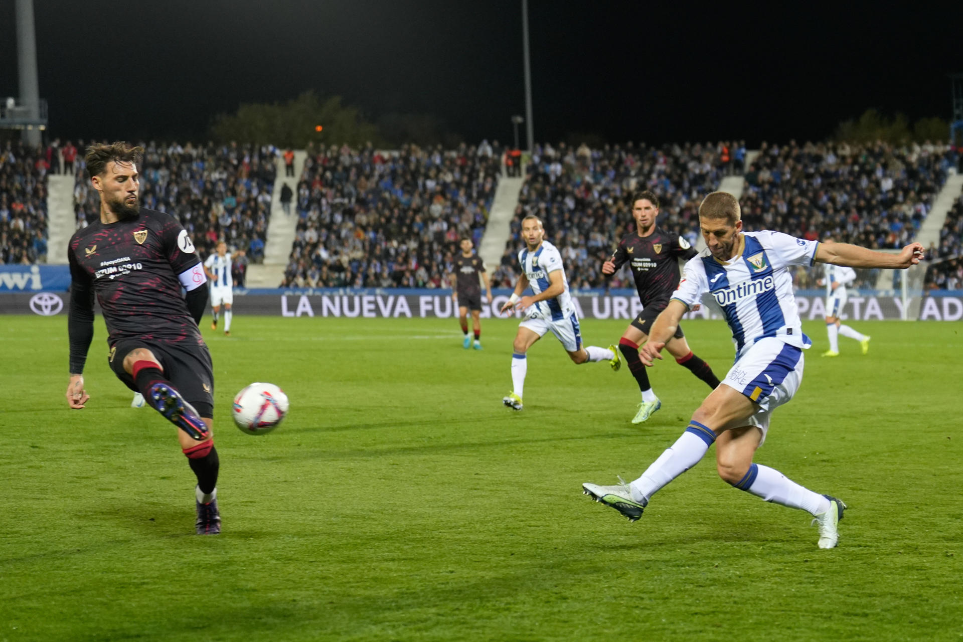 El defensa del Sevilla Adrià Pedrosa (i) y el centrocampista serbio del Leganés Darko Brasanac durante el partido de LaLiga entre el Leganés y el Sevilla, este sábado en el estadio de Butarque. EFE/ Borja Sanchez-Trillo 