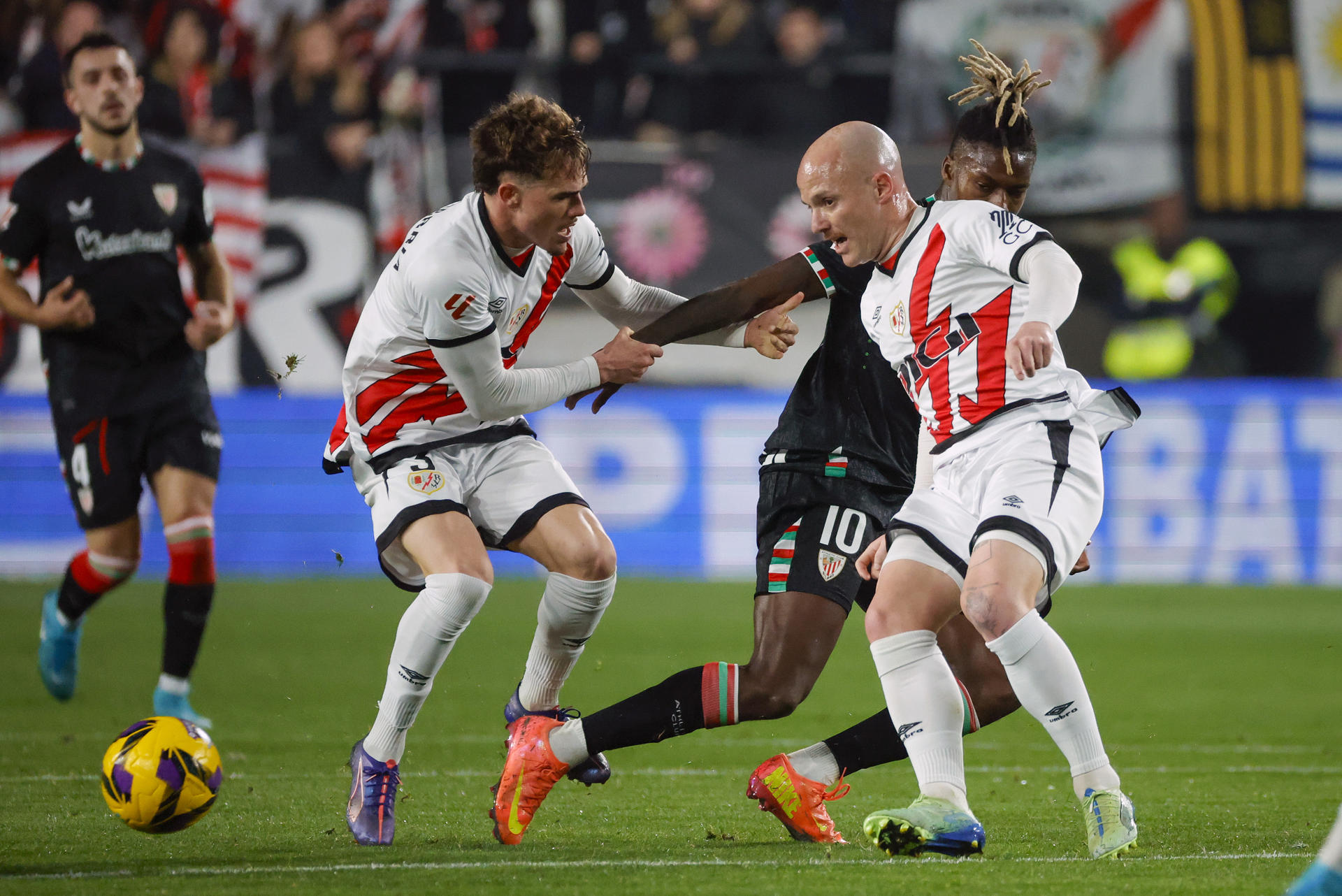 Los jugadores del Rayo Josep Chavarría (2-i) e Isi Palazón (2-d) pelean un balón con Nico Williams (d), del Athletic, durante el partido de LaLiga en el estadio de Vallecas, en Madrid. EFE/Zipi 