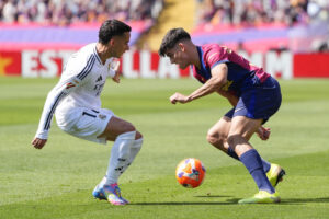 El centrocampista del Barcelona Pedri y el defensa del Real Madrid Lucas Vázquez, durante el partido de la jornada 35 de LaLiga EA Sports entre el Barcelona y el Real Madrid, este domingo en el Estadi Olímpic Lluís Companys.-EFE/ Siu Wu
