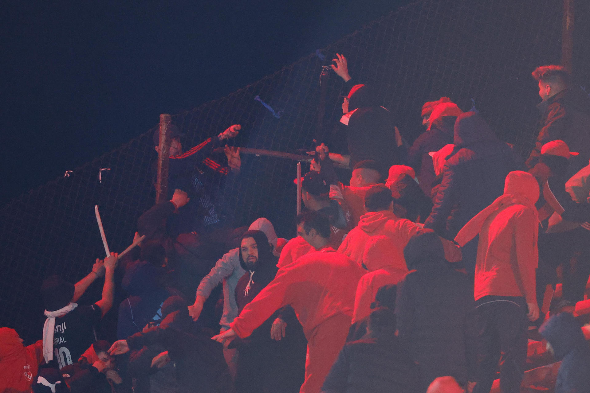 Fanáticos de Independiente y la Universidad de Chile se enfrentan este miércoles en una tribuna del Estadio Libertadores der América de la ciudad argentina de Avellaneda con graves consecuencias que obligaron a la cancelación del partido de vuelta de los octavos de final de la Copa Sudamericana. EFE/ Juan Ignacio Roncoroni 