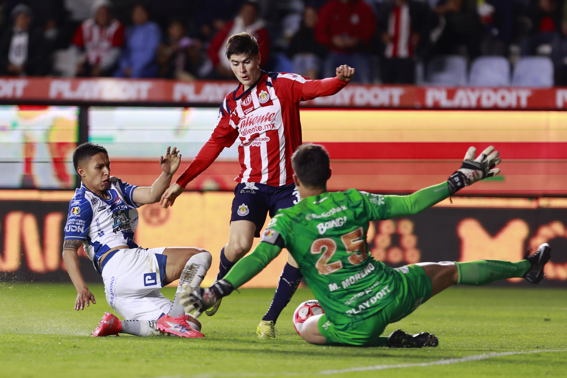 Jorge Berlanga (i) y el portero Carlos Moreno (d) de Pachuca disputan el balón con el delantero de Guadalajara Armando Gonzáalez durante el partido jugado este domingo en el estadio Hidalgo. EFE / David Martínez Pelcastre 