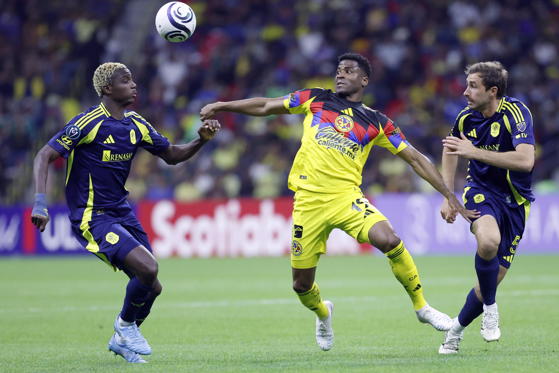 Raul Zúñiga (c) de América disputa un balón con Maxwell Woledzi (i) y Jack Maher de Nashville este martes, en el partido por los cuartos de final de la Copa de Campeones de la Concacaf disputado en el estadio Banorte en Ciudad de México (México). EFE/Sáshenka Gutiérrez 