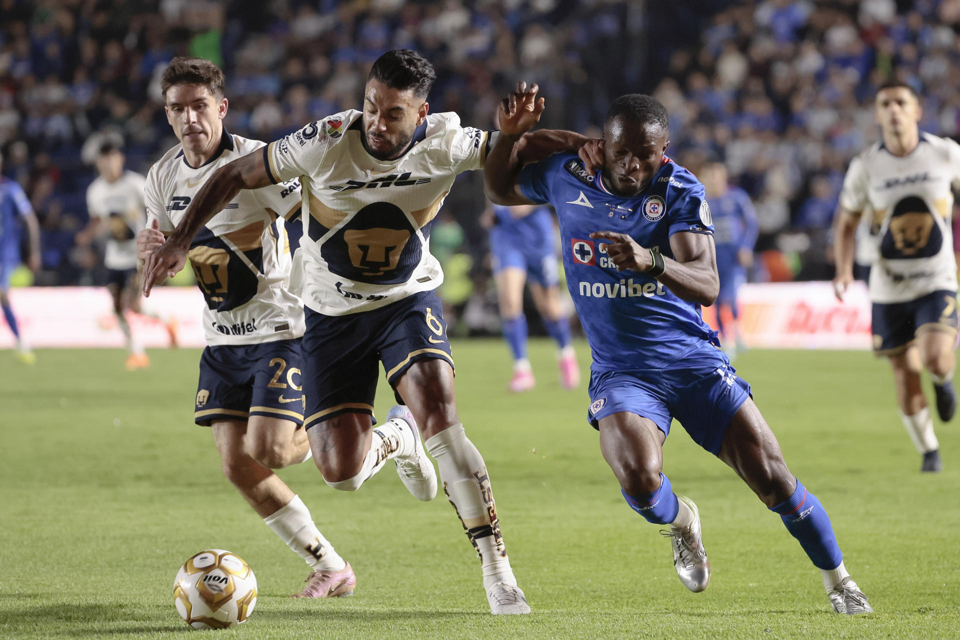 Osinachi Ebere (d) de Cruz Azul disputa el balón con Nathanael Ananias Da Silva de Pumas este jueves, en el partido de ida de la final de la Liga MX entre Cruz Azul y Pumas en el estadio Ciudad de los Deportes en Ciudad de México (México). EFE/ José Méndez