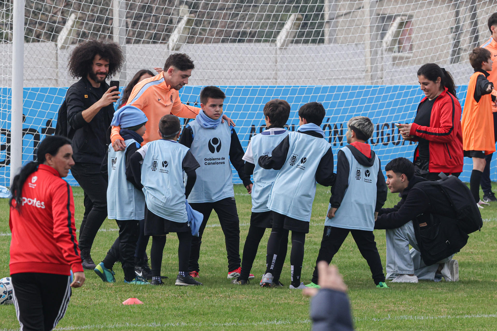 Jugadores de la selección de fútbol de Uruguay participan en un evento de despedida con niños este viernes en el estadio Tito López López, en Pando, Canelones. EFE/ Gastón Britos