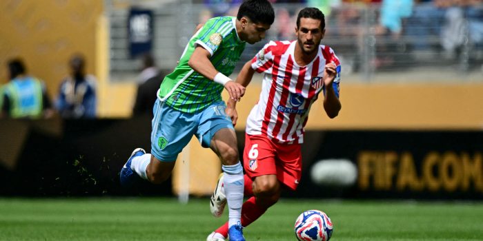 Seattle Sounders' Mexican midfielder #18 Obed Vargas and Atletico Madrid's Spanish midfielder #06 Koke fight for the ball during the FIFA Club World Cup 2025 Group B football match between US Seattle Sounders and Spain's Atletico de Madrid at the Lumen Field stadium in Seattle on June 19, 2025. (Photo by Pablo PORCIUNCULA / AFP)