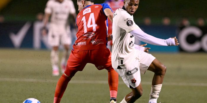 Xelaju's defender #14 Javier Gonzalez and Alajuelense's forward #21 Kenyel Michel fight for the ball during the second leg of the CONCACAF Central American Cup final football match between Guatemala's Xelaju and Costa Rica's Alajuelense at Mario Camposeco Stadium in Quetzaltenango, Guatemala, on December 3, 2025. (Photo by JOHAN ORDONEZ / AFP)