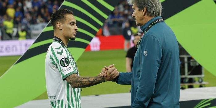 El delantero brasileño del Betis, Antony y el técnico chileno, Manuel Pellegrini, se saludan tras recibir la medalla de subcampeones de la Liga Europa. EFE / Julio Muñoz.