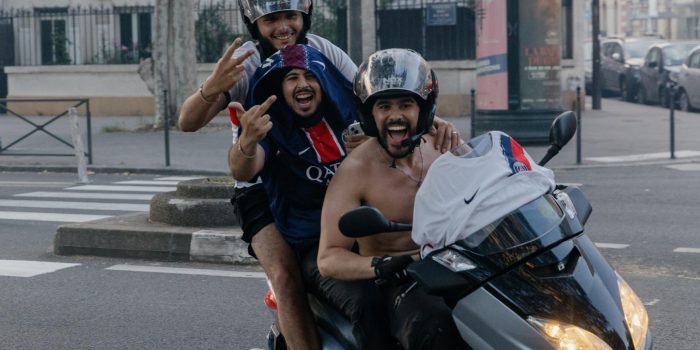 Tres aficionados del PSG sobre una motocicleta celebran el sábado, en París, la victoria de su equipo en la final de la Liga de Campeones contra el Arsenal. EFE/EPA/VALENTINA CAMU