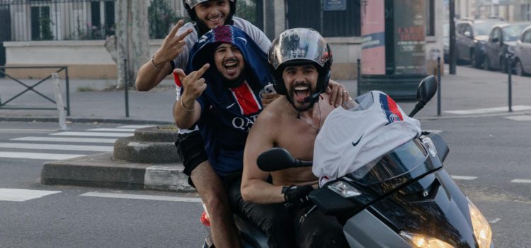 Tres aficionados del PSG sobre una motocicleta celebran el sábado, en París, la victoria de su equipo en la final de la Liga de Campeones contra el Arsenal. EFE/EPA/VALENTINA CAMU