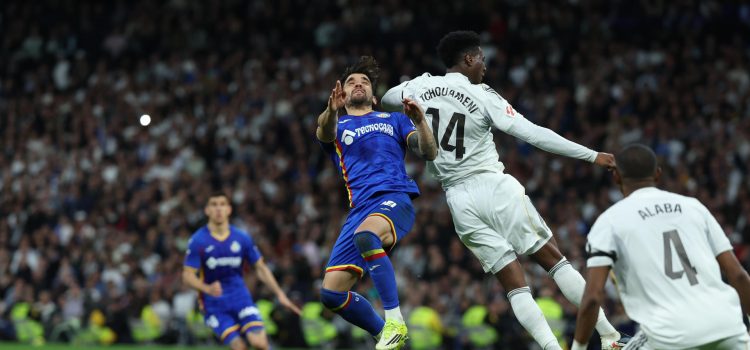 El centrocampista francés del Real Madrid, Aurélien Tchouaméni (d), disputa el balón ante el centrocampista uruguayo del Getafe, Mauro Arambarri, durante el encuentro correspondiente a la jornada 26 de Laliga EA Sports que disputaron en el estadio Santiago Bernabéu, en Madrid. EFE / Kiko Huesca.