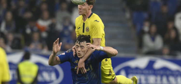 El defensa del Villarreal Pau Navarro (arriba) salta por un balón con el uruguayo Fede Viñas, del Oviedo, durante el partido de la jornada 33 de LaLiga de fútbol que Real Oviedo y Villarreal CF disputan este jueves en el estadio Carlos Tartiere. EFE/Eloy Alonso