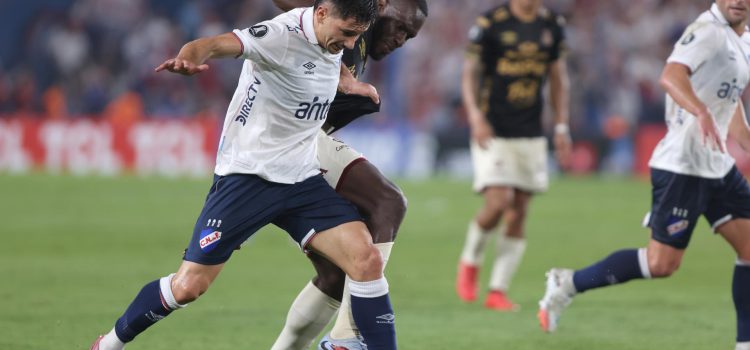 Maximiliano Silvera (i), de Nacional, disputa el balón con Anderson Angulo, de Tolima, este martes durante un partido de la Copa Libertadores en el estadio Gran Parque Central, en Montevideo. EFE/ Gastón Britos