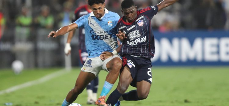 Cristiano (i) de Sporting Cristal disputa el balón con Joel Canchimbo de Junior este martes durante el partido de la tercera jornada de la fase de grupos de la Copa Libertadores jugado en el estadio Alejandro Villanueva en Lima. EFE/ Paolo Aguilar